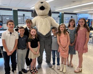 elementary school students with stuffed dog