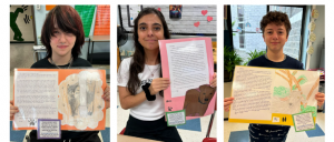 three students with posters